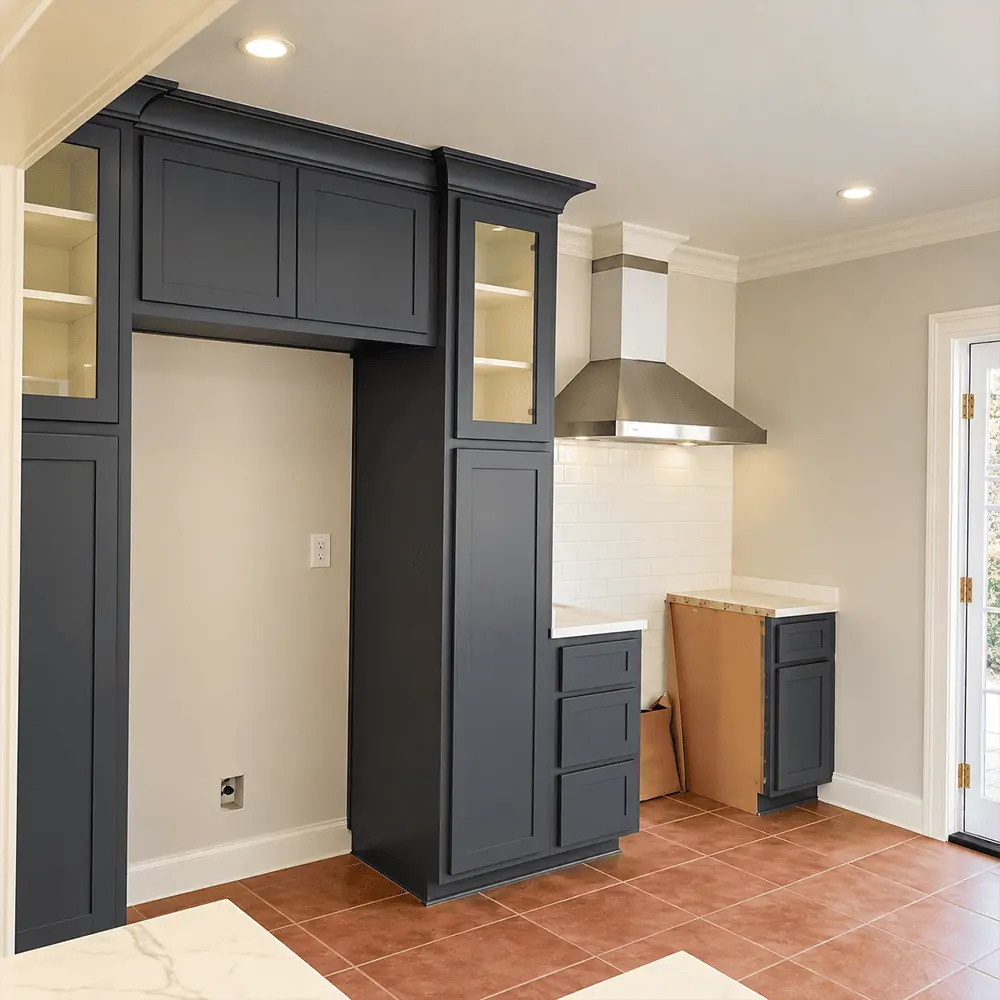 Dark gray custom fridge cabinet and pantry wall with glass front uppers