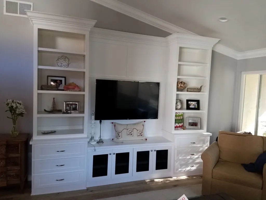 White built in entertainment center with open shelves