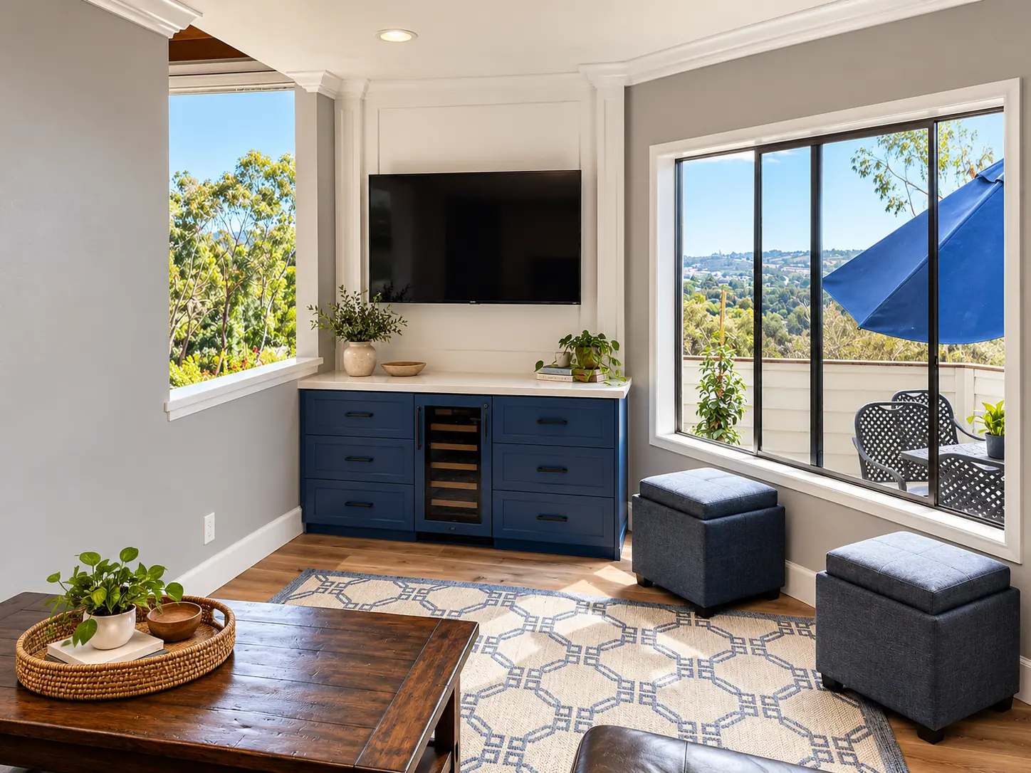 Navy built in media console under wide windows with a hillside view
