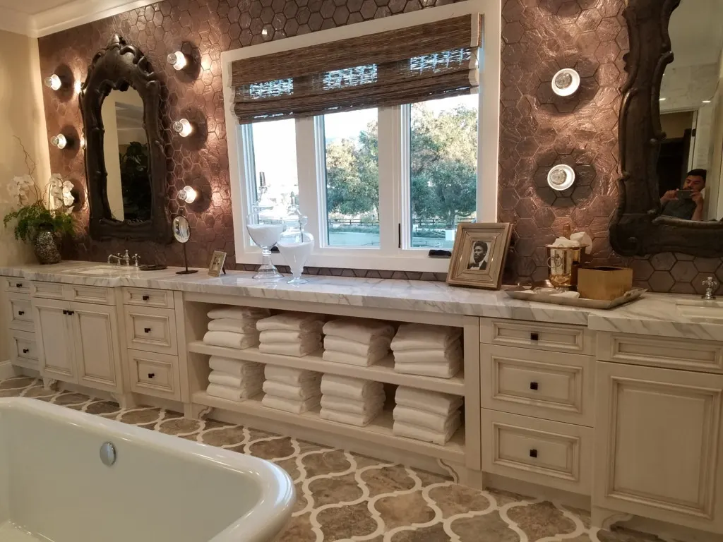 Cream bathroom vanity with open towel shelves