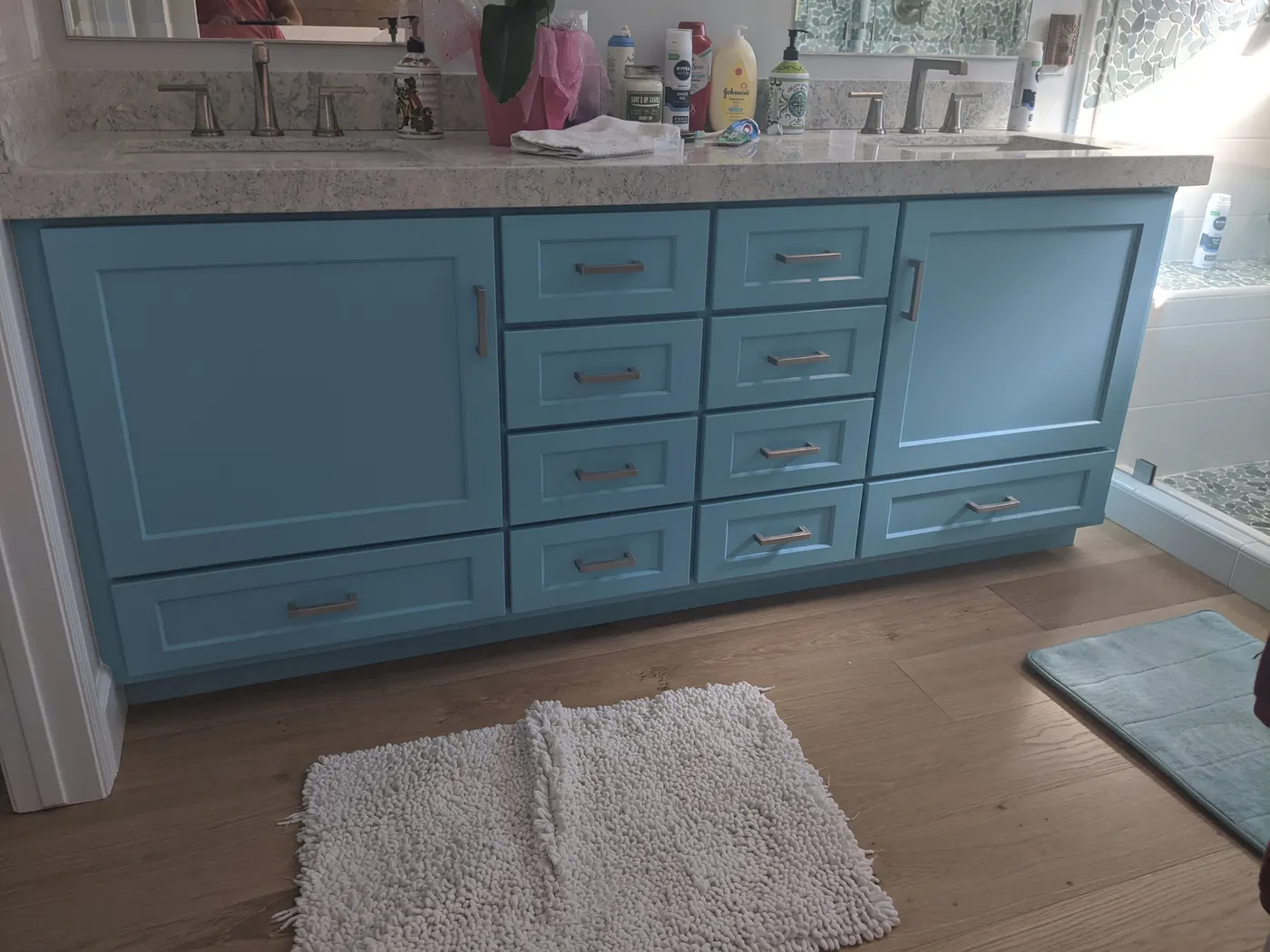 Teal custom bathroom vanity cabinet with a stone top