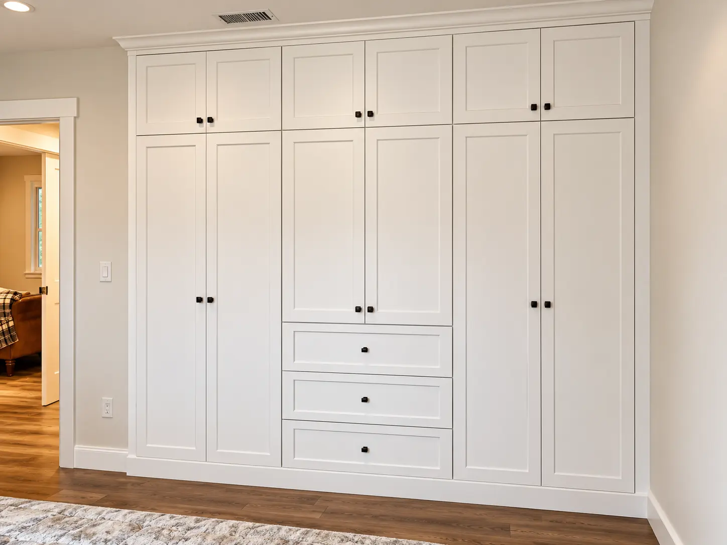 White built in wardrobe wall with paneled doors and drawers