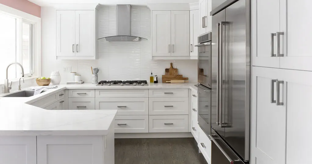 White shaker kitchen cabinets with stainless appliances