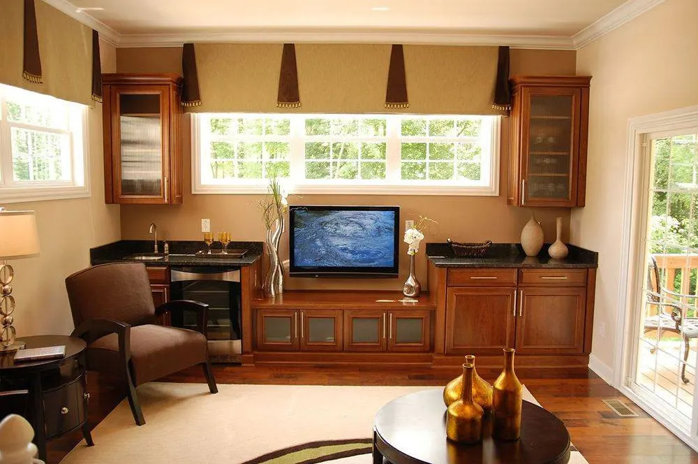 Stained wood media wall under a row of windows